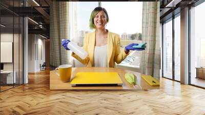 Woman cleaning equipment, teleworking, and prevention against coronavirus Wall mural