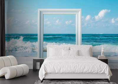 A white picture frame against a beach with white sand and blue waves Wall mural