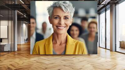 Attractive businesswoman woman posing at her work place with coworkers in the background. Generative AI	 Wall mural