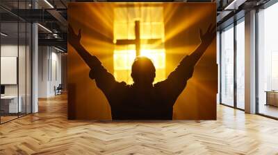 backlit image of a believer hands to heaven worshiping the cross Wall mural