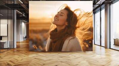 Backlit Portrait of calm happy smiling free woman with closed eyes enjoys a beautiful moment life on the fields at sunset Wall mural