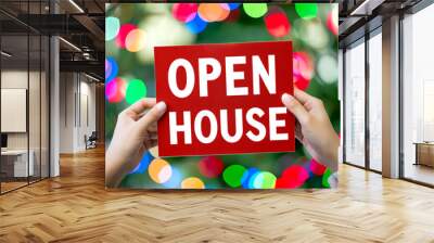 female hands holding an OPEN HOUSE sign in a colorful background Wall mural