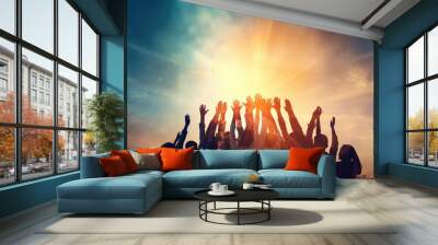 Hands to heaven, group of people with their hands up looking at the sunset Wall mural