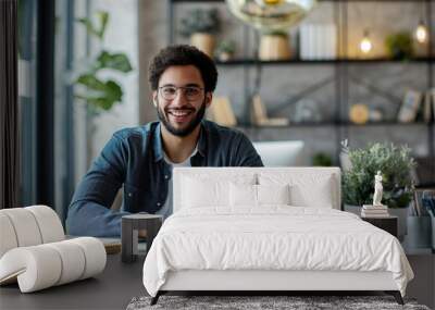 Happy successful modern young middle eastern businessman working with his laptop at his office  Wall mural