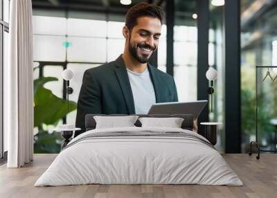 Happy young business man executive holding pad computer at work. Male professional employee using digital tablet fintech device standing in office checking financial online market data Wall mural