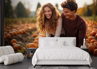 Happy young couple in pumpkin patch field Wall mural