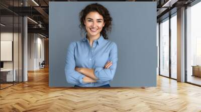 Happy young smiling confident professional business woman wearing blue shirt, pretty stylish female executive looking at camera, standing arms crossed isolated at gray background, Generative AI Wall mural