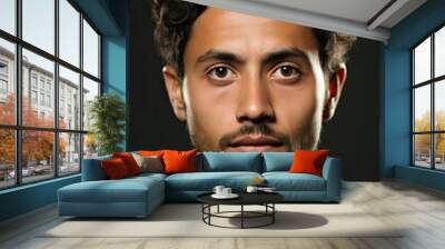 headshot of a young hispanic man looking at the camera on gray background Wall mural