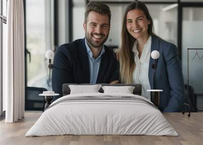 Male and female business couple posing smiling at their business office looking at the camera Wall mural