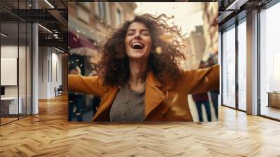 Portrait of overjoyed attractive woman standing with excited expression, raising fists, screaming, shouting yeah, celebrating her victory, success. Wall mural