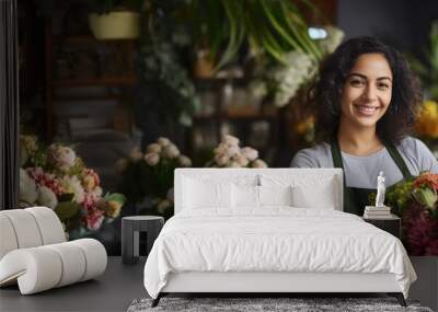 Smiling attractive hispanic female Small business owner in her florist shop Wall mural