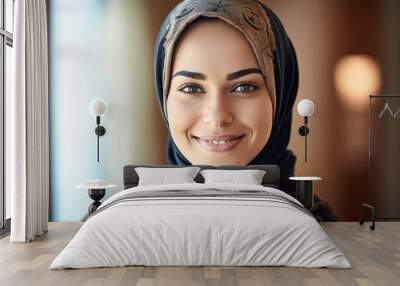 Smiling beautiful middle eastern young woman wearing a hijab looking at the camera Wall mural