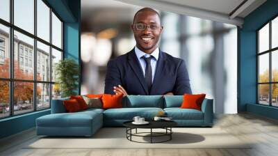 Smiling black executive posing with his arms crossed at the office looking at the camera Wall mural