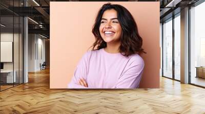 Smiling happy attractive hispanic young woman posing in studio shot Wall mural