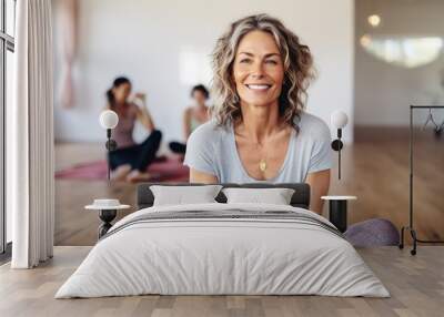 Smiling Mature woman meditating sitting in a yoga studio. Generative AI Wall mural