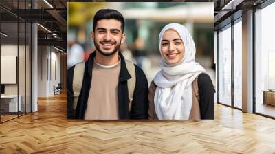 Smiling middle eastern students looking at the camera male and female. Wall mural