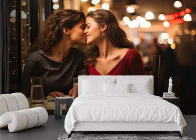 Young lesbian couple in their moment of intimacy having dinner at a restaurant  Wall mural