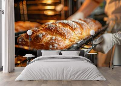 Person taking tray with fresh bread out of the oven Wall mural