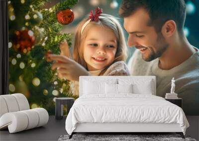 Smiling young father and daughter decorating a Christmas tree with lights and ornaments. Wall mural