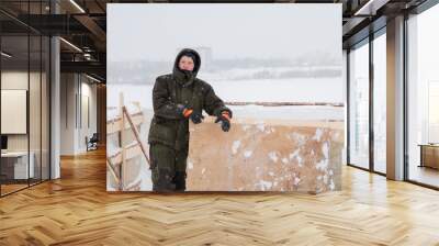 Portrait of a worker in overalls at a construction site Wall mural