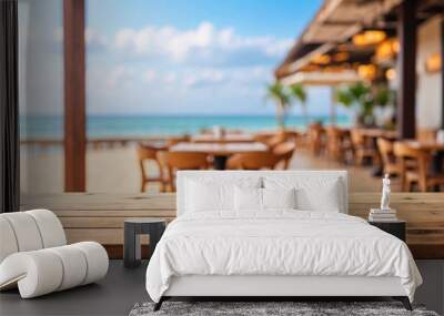 The empty wooden table top with blur background of restaurant on the beach. For product display Wall mural