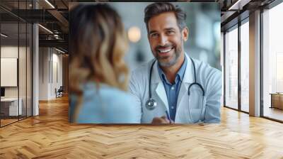 Indian male doctor consulting patient filling form at consultation. wearing white coat talking to woman signing medical paper at appointment visit in hospital ward. white room. day light. Wall mural