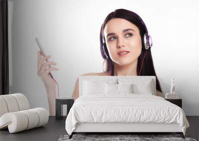 beautiful cute brunette girl with headphones on a white background, Place for text, Wall mural