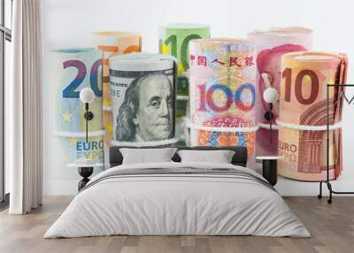 Currencies and money exchange trading concepts. The rolls of various currencies US Dollar, Euro and Chinese yuan banknotes isolated on white background. Wall mural