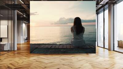 silhouette of young woman sitting alone on back side outdoor at tropical island beach missing boyfri Wall mural