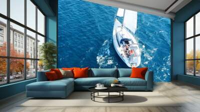 Aerial birds eye view from drone of yacht in deep blue sea Wall mural