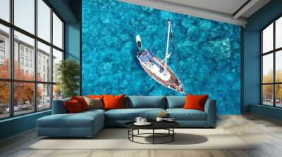 Aerial drone photo of luxury sail boat docked in tropical exotic bay with turquoise crystal clear sea Wall mural