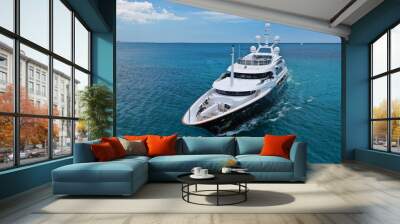 Aerial drone photo of modern luxury yacht cruising near Mediterranean port Wall mural