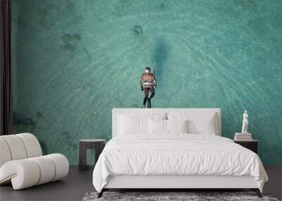 Aerial drone top down ultra wide panoramic photo of spearfishing scuba diver in tropical exotic shallow bay with turquoise clear waters Wall mural