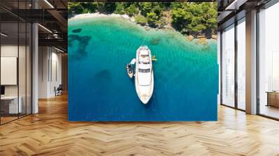 Aerial drone ultra wide panoramic photo of luxury yacht anchored in tropical exotic island with crystal clear turquoise sea and pine trees Wall mural