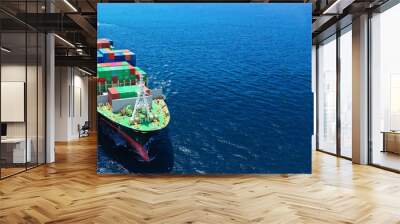 Aerial drone ultra wide photo of fully loaded container cargo ship cruising in open ocean deep blue sea Wall mural