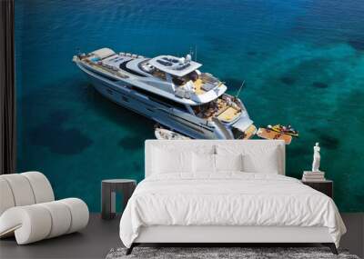 Aerial drone ultra wide photo of luxury yacht docked in tropical exotic island with turquoise sea Wall mural