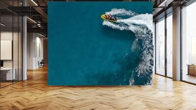 Aerial photo of jet ski with couple cruising in high speed in Caribbean tropical crystal clear waters Wall mural