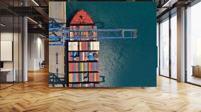 Aerial top down ultra wide photo of industrial cargo container ship loading in logistics terminal port Wall mural