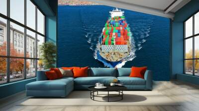 defauAerial drone photo of Container cargo Ship carrying load in truck-size colourful containers cruising deep blue open ocean sea  Wall mural