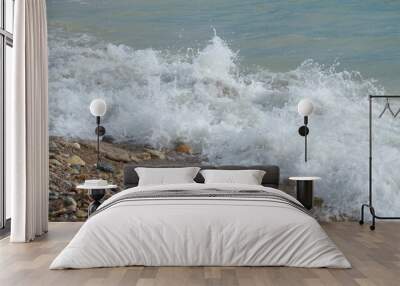 Mediterranean rocky beach with wavy sea in a cloudy morning Wall mural