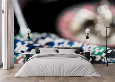 High contrast image of casino roulette and poker chips on bokeh background. Wall mural