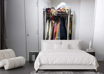 colorful collection of various garments and costumes on a clothing rack in storage room Wall mural