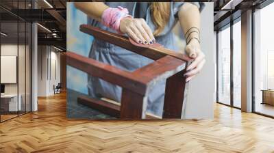 detail of woman restoring furniture Wall mural