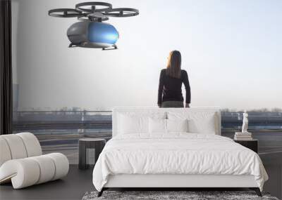 flying transportation drone picking up a passenger Wall mural