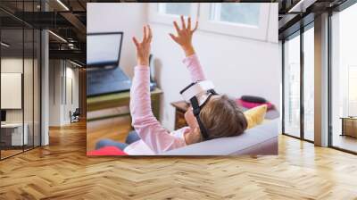 young girl looking through VR goggles Wall mural