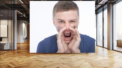 Attractive young man shouting Wall mural