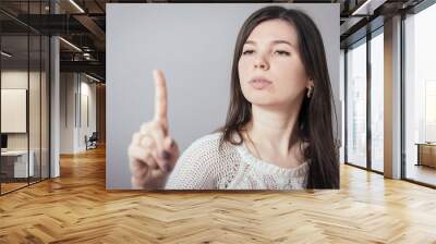 girl pointing at something invisible Wall mural