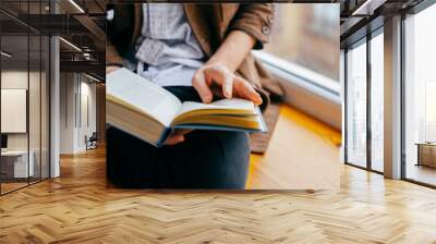 Young man reading a book Wall mural