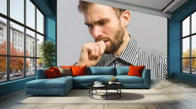 young man with a beard thinking with hand on face Wall mural