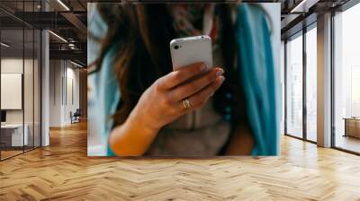 Young woman dials number on mobile phone Wall mural